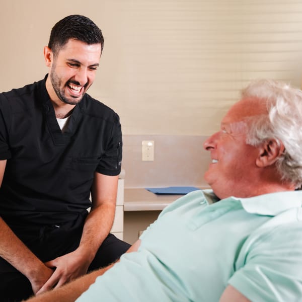 Dr. Marabeh laughing with an older patient
