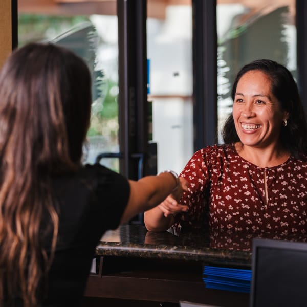 North County Dental Arts receptionist shaking hands with a client